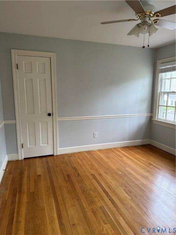 20 Jonquil Lane, Newport News, VA 23606 Room featuring wood-finish flooring, chair rail molding, a six-panel door, and a ceiling fan with integrated lighting