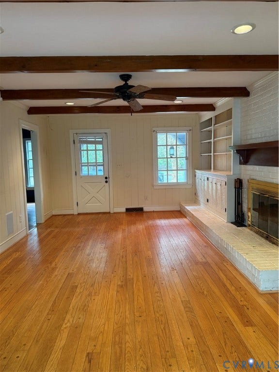 20 Jonquil Lane, Newport News, VA 23606 Exposed ceiling beams, wood-finish flooring, white brick fireplace with a wood mantel, built-in cabinetry, and multi-pane glass door