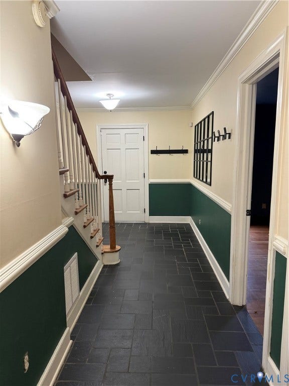 20 Jonquil Lane, Newport News, VA 23606 Foyer featuring slate tile flooring, wainscoting with decorative chair rail, and a staircase with stained wood handrail and white balusters