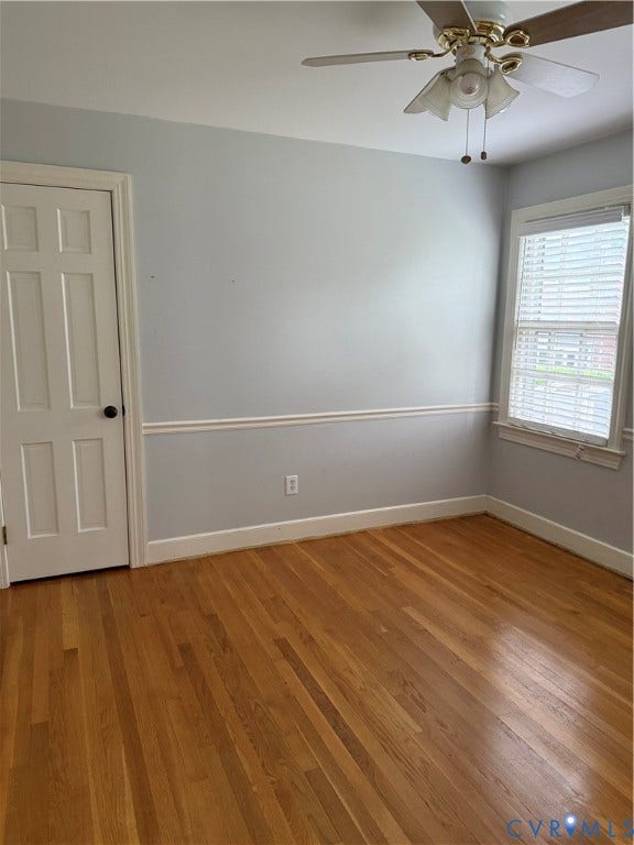20 Jonquil Lane, Newport News, VA 23606 Interior room featuring wood-finish flooring, chair rail molding, a single-panel door, and a ceiling fan with integrated light fixture