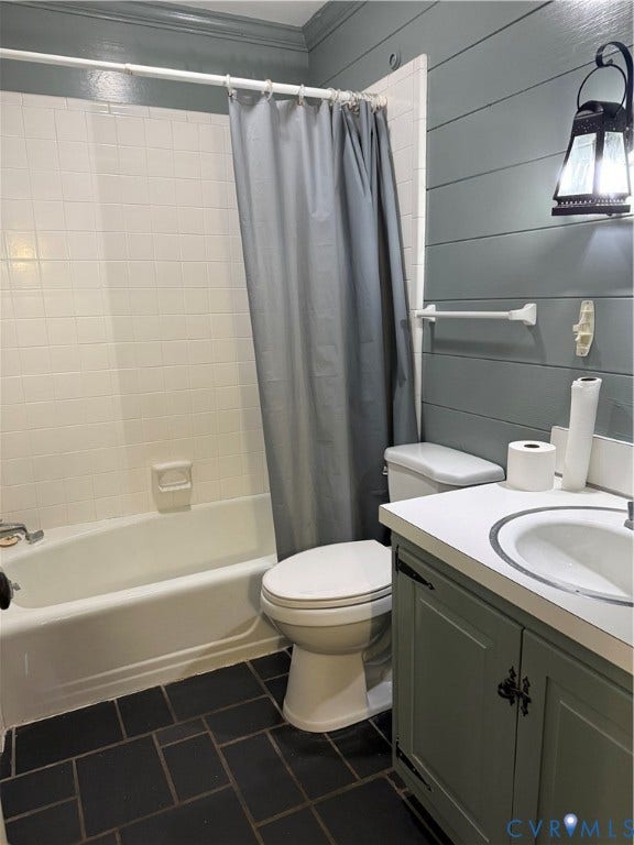 20 Jonquil Lane, Newport News, VA 23606 First Floor Bathroom featuring horizontal plank wall paneling, vanity with integrated basin and countertop, tiled tub surround, and dark-toned floor tile
