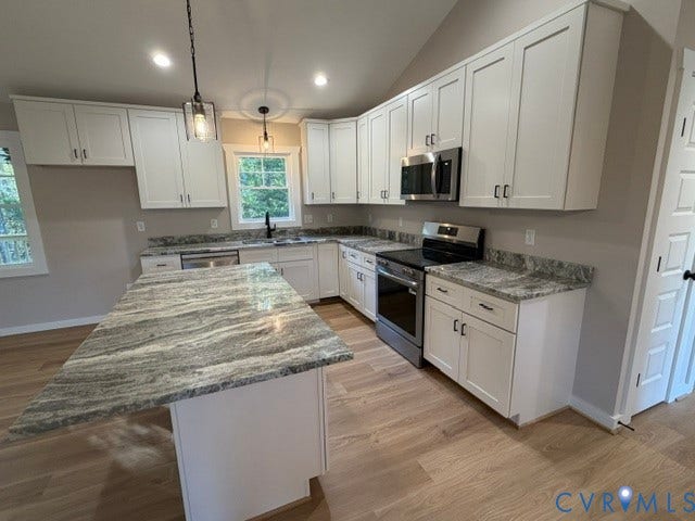 745 Gully Tavern Road, Detached, Rice, VA 23966 Kitchen featuring white shaker-style cabinetry, a stone countertop island, stainless steel appliances, and wood-finish flooring under a vaulted ceiling
