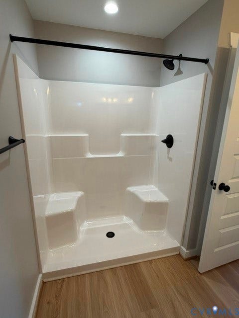 745 Gully Tavern Road, Detached, Rice, VA 23966 White shower surround featuring integrated seating, matte black plumbing fixtures, and a coordinating matte black shower rod