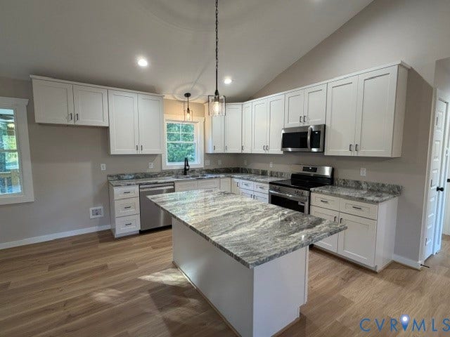 745 Gully Tavern Road, Detached, Rice, VA 23966 Kitchen featuring white shaker-style cabinetry, stone-patterned countertops, a central island, stainless steel appliances, and wood-finish flooring