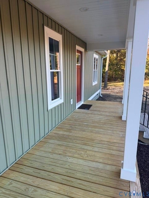 745 Gully Tavern Road, Detached, Rice, VA 23966 Covered front porch featuring vertical board-and-batten siding, natural wood decking, and white structural support columns