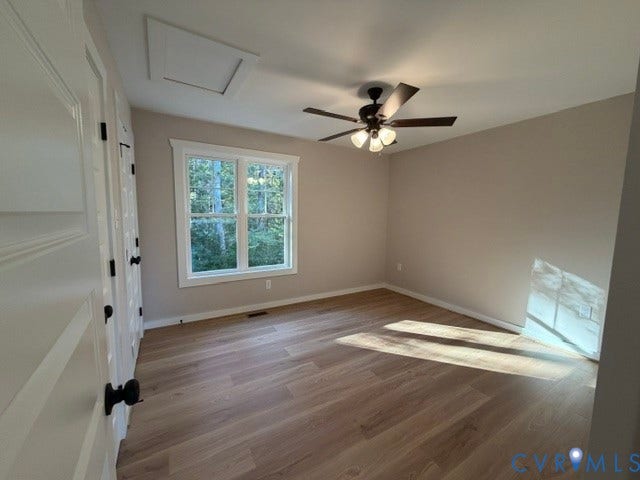 745 Gully Tavern Road, Detached, Rice, VA 23966 Neutral-toned interior featuring wood-finish flooring, multi-pane window, ceiling fan with light kit, and paneled doors