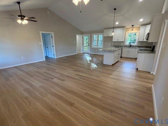 745 Gully Tavern Road, Detached, Rice, VA 23966 Open-concept floor plan featuring vaulted ceilings, wood-finish flooring, kitchen island, white shaker-style cabinetry, and pendant lighting