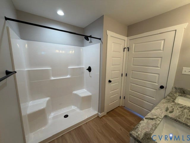 745 Gully Tavern Road, Detached, Rice, VA 23966 Walk-in shower with integrated seating and matte black hardware, dual-sink vanity with patterned stone countertop, and five-panel interior doors