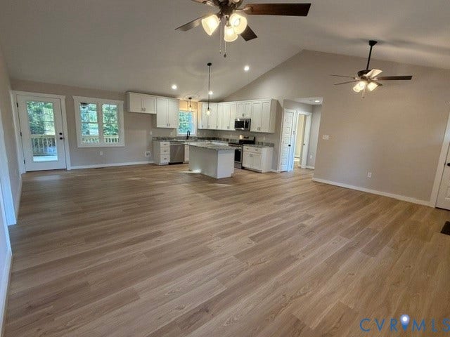 745 Gully Tavern Road, Detached, Rice, VA 23966 Open-concept kitchen featuring white cabinetry, a center island, stone-finish countertops, wood-finish flooring, and vaulted ceilings