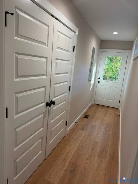 745 Gully Tavern Road, Detached, Rice, VA 23966 Wood-finish flooring, white five-panel interior doors with matte black hardware, and an exterior door featuring a glass inset and matching matte black hardware