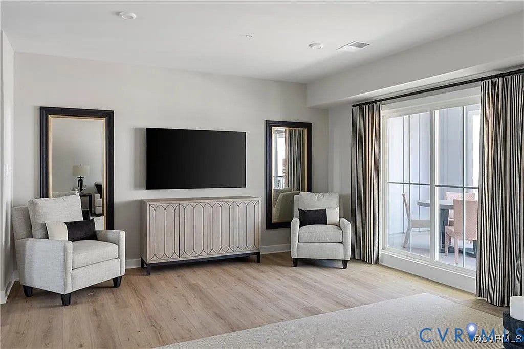 Interior space featuring wood-finish flooring, recessed lighting, and a floor-to-ceiling glass sliding door providing exterior access
