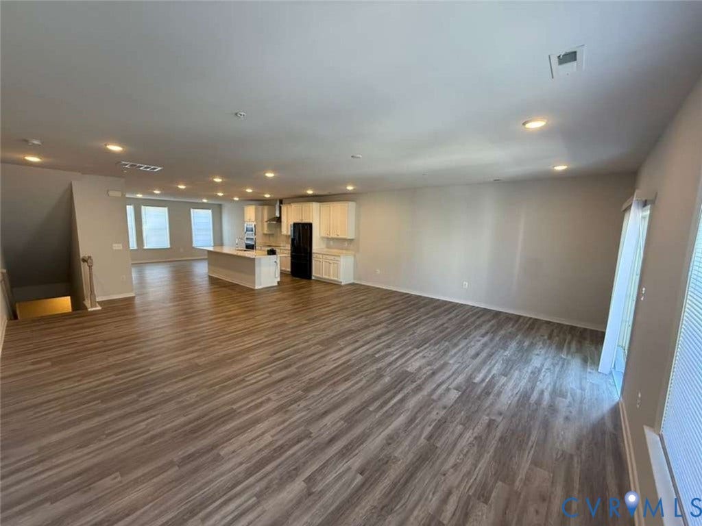 5912 Whitehurst Lane, #B, Henrico, VA 23227 Open-concept interior featuring wood-finish flooring, recessed lighting, white cabinetry, a center kitchen island, and sliding glass doors