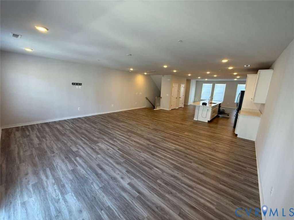 5912 Whitehurst Lane, #B, Henrico, VA 23227 Open-concept interior featuring wood-finish flooring, recessed lighting, and a kitchen island with a built-in sink