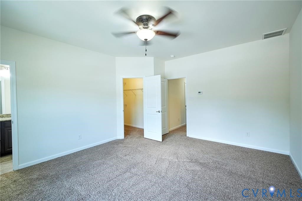 11316 Duncan park Court, Glen Allen, VA 23060 Neutral wall tones, wall-to-wall carpeting, ceiling fan with integrated lighting, and a walk-in closet with built-in shelving