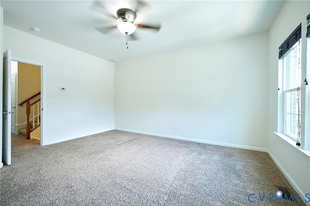 11316 Duncan park Court, Glen Allen, VA 23060 Neutral-toned carpeting, ceiling fan with integrated lighting, and window with dark-toned frame
