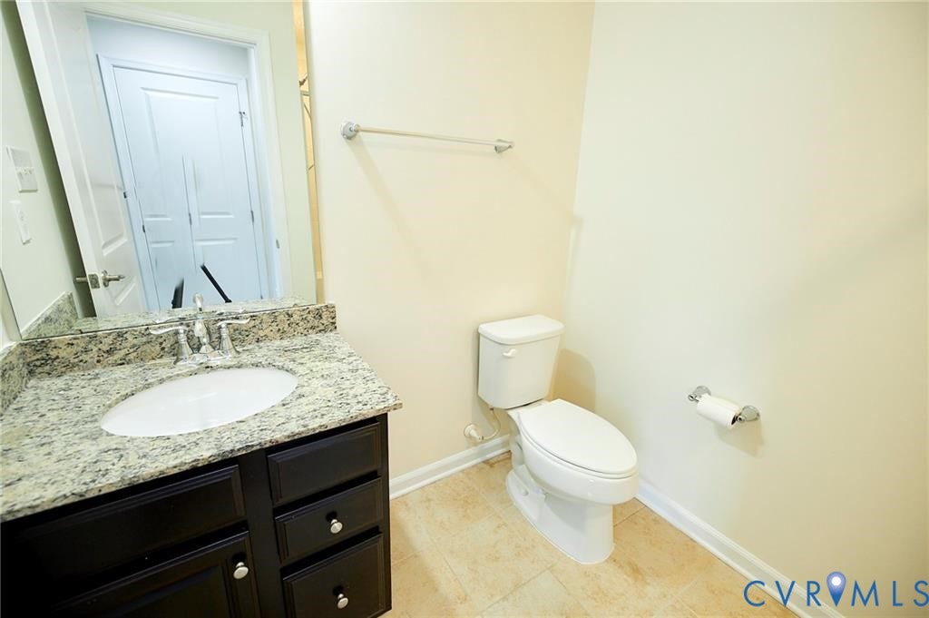 11316 Duncan park Court, Glen Allen, VA 23060 Dark-finish vanity cabinetry with stone-patterned countertop, integrated porcelain sink, chrome faucet, and tile flooring
