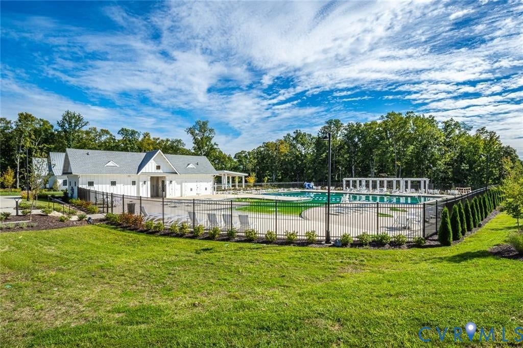 338 Hay Mill Alley, Glen Allen, VA 23060 Swimming pool enclosed by black metal fencing, featuring a concrete pool deck, attached pool house, and a pergola-covered patio area