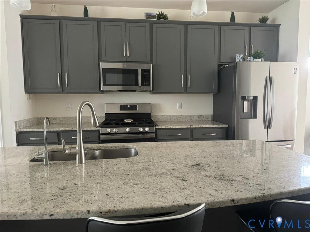 338 Hay Mill Alley, Glen Allen, VA 23060 Kitchen featuring stone countertops, dark cabinetry, stainless steel appliances, a gas range, and a dual-basin undermount sink with a high-arch faucet