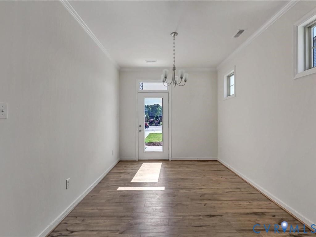 338 Hay Mill Alley, Glen Allen, VA 23060 Interior space featuring wood-finish flooring, a multi-arm chandelier, crown molding, and a glass-panel entry door with a transom window
