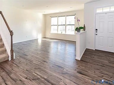 338 Hay Mill Alley, Glen Allen, VA 23060 Wood-finish flooring, staircase with a wood-finish handrail, multi-pane windows, and white six-panel entry door with transom window