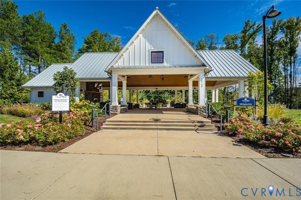 338 Hay Mill Alley, Glen Allen, VA 23060 Open-air pavilion featuring a gabled roof, board-and-batten siding, stone-base columns, metal roofing, and a concrete patio