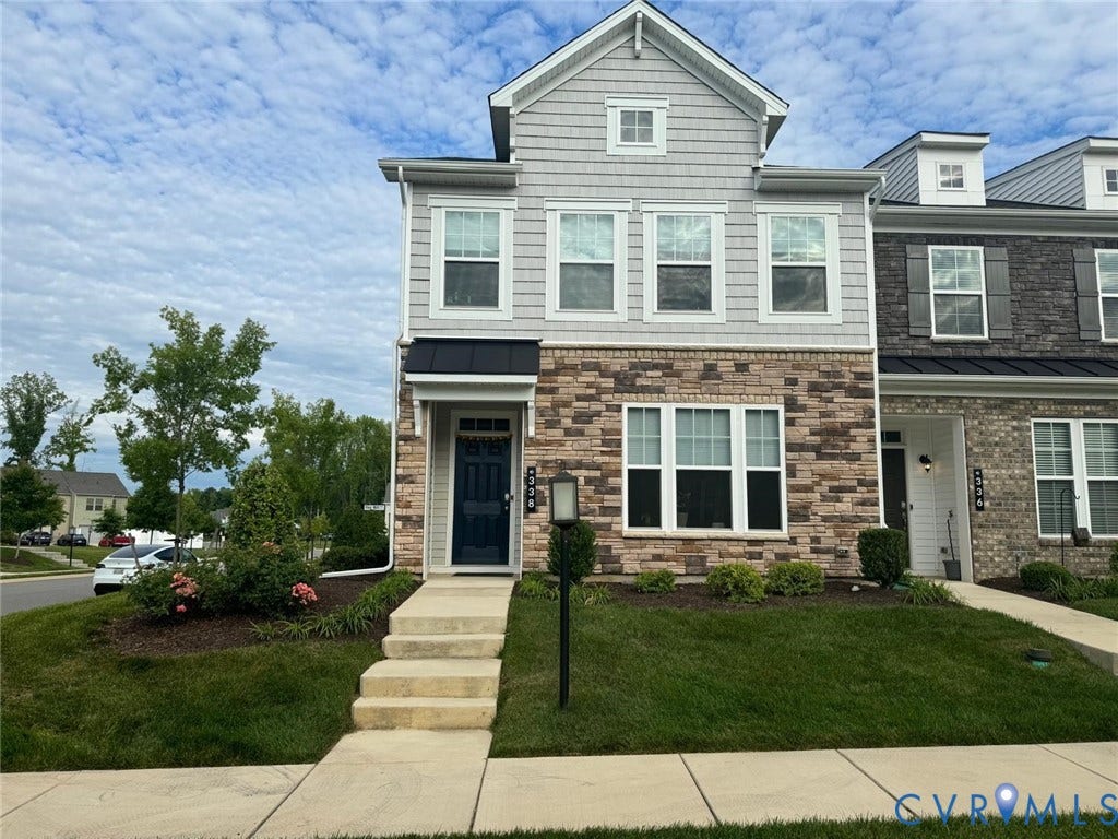 338 Hay Mill Alley, Glen Allen, VA 23060 Multi-story townhome exterior featuring stone veneer siding, horizontal lap and shingle siding, a metal-roofed entryway awning, and multi-pane windows