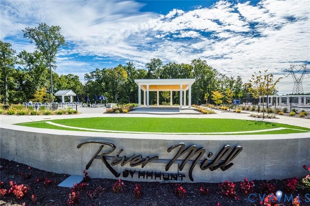 338 Hay Mill Alley, Glen Allen, VA 23060 Community grounds featuring a concrete retaining wall, manicured turf lawn, open-air pavilion, and landscaped beds