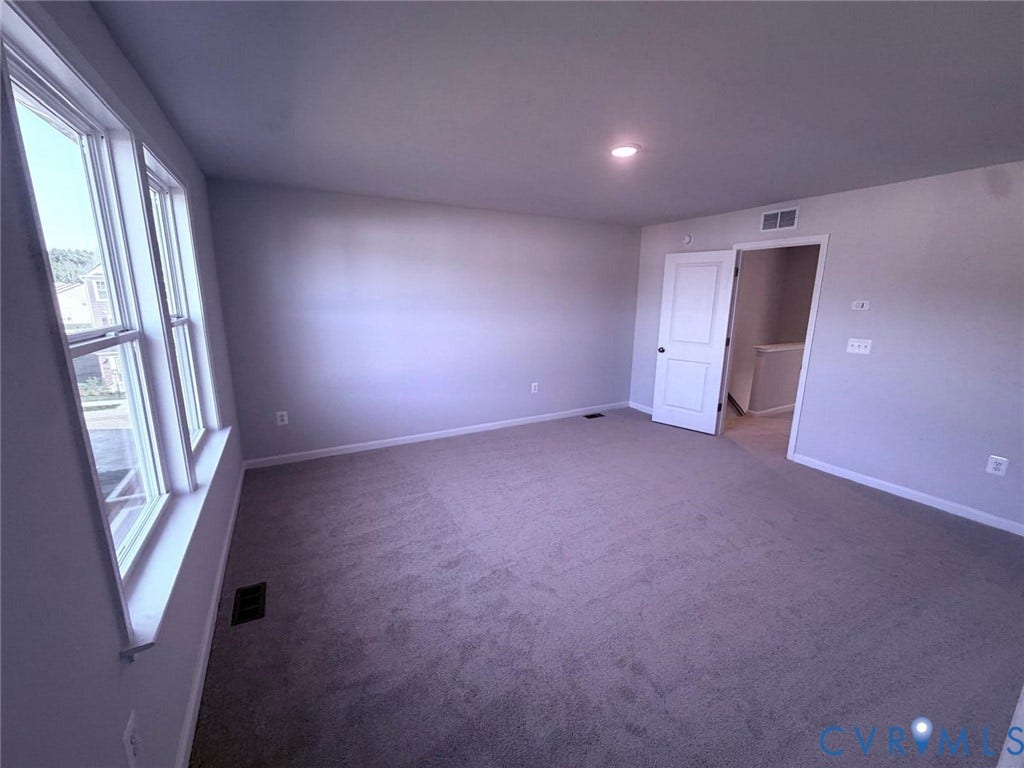 504 Sybil Street, Glen Allen, VA 23060 Neutral-toned interior featuring plush carpeting, multiple paneled windows, recessed lighting, and a solid-core interior door