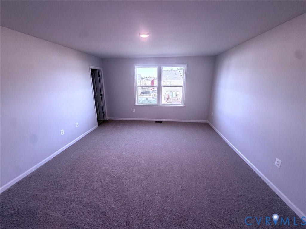504 Sybil Street, Glen Allen, VA 23060 Neutral-toned interior featuring wall-to-wall carpeting, expansive painted walls, and a dual-pane window with white trim