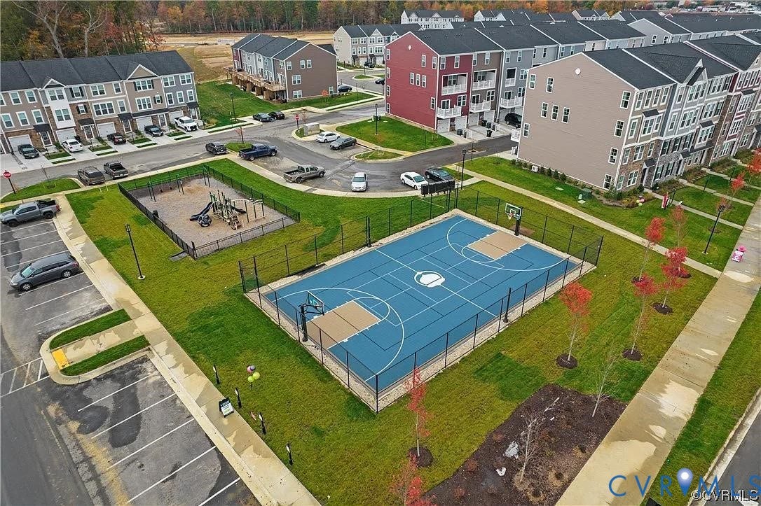 504 Sybil Street, Glen Allen, VA 23060 Community recreation area featuring a fenced basketball court with blue hardscaping, a designated playground, and surrounding paved parking