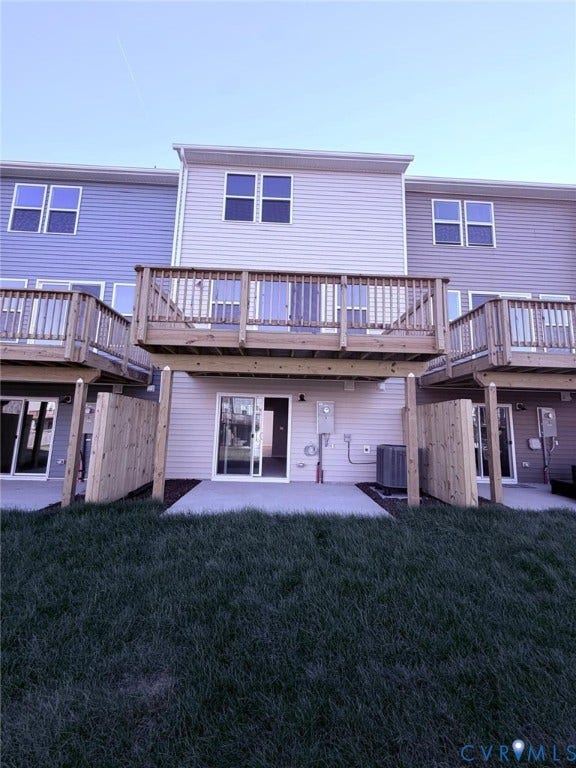504 Sybil Street, Glen Allen, VA 23060 Multi-level townhome exterior featuring horizontal siding, an elevated wood deck, a concrete ground-level patio, and wood privacy fencing