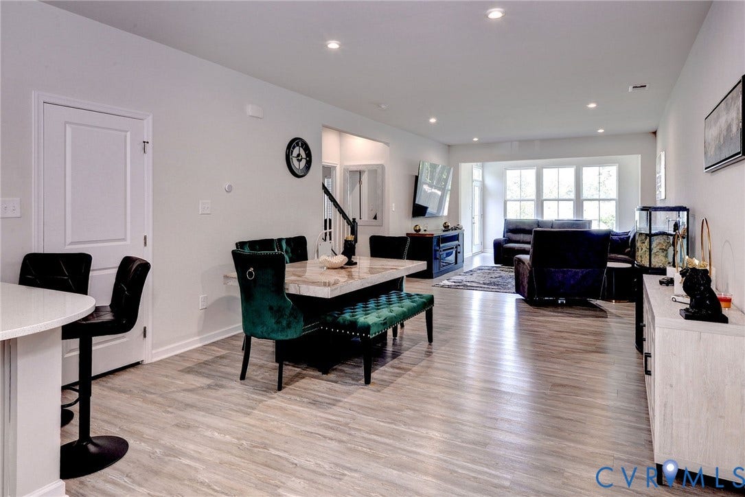 3415 Foxglove Drive, Toano, VA 23168 Open-concept interior featuring wood-finish flooring, recessed lighting, and expansive windows