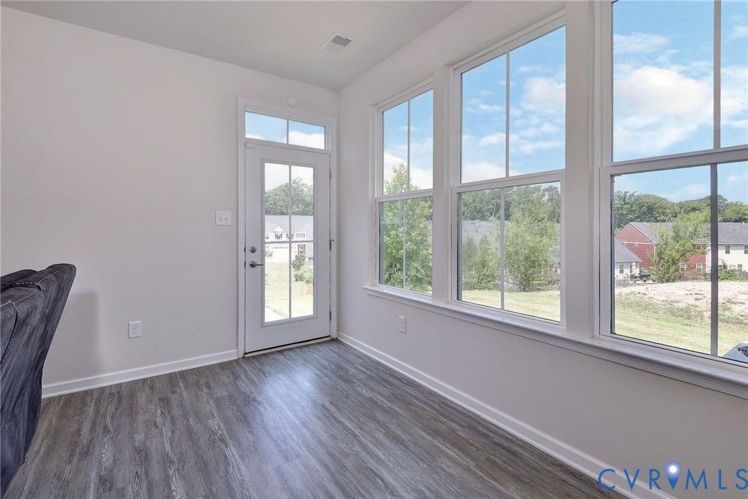 3415 Foxglove Drive, Toano, VA 23168 Sunroom featuring wood-finish flooring, extensive multi-pane windows, and a glass-paneled exterior door