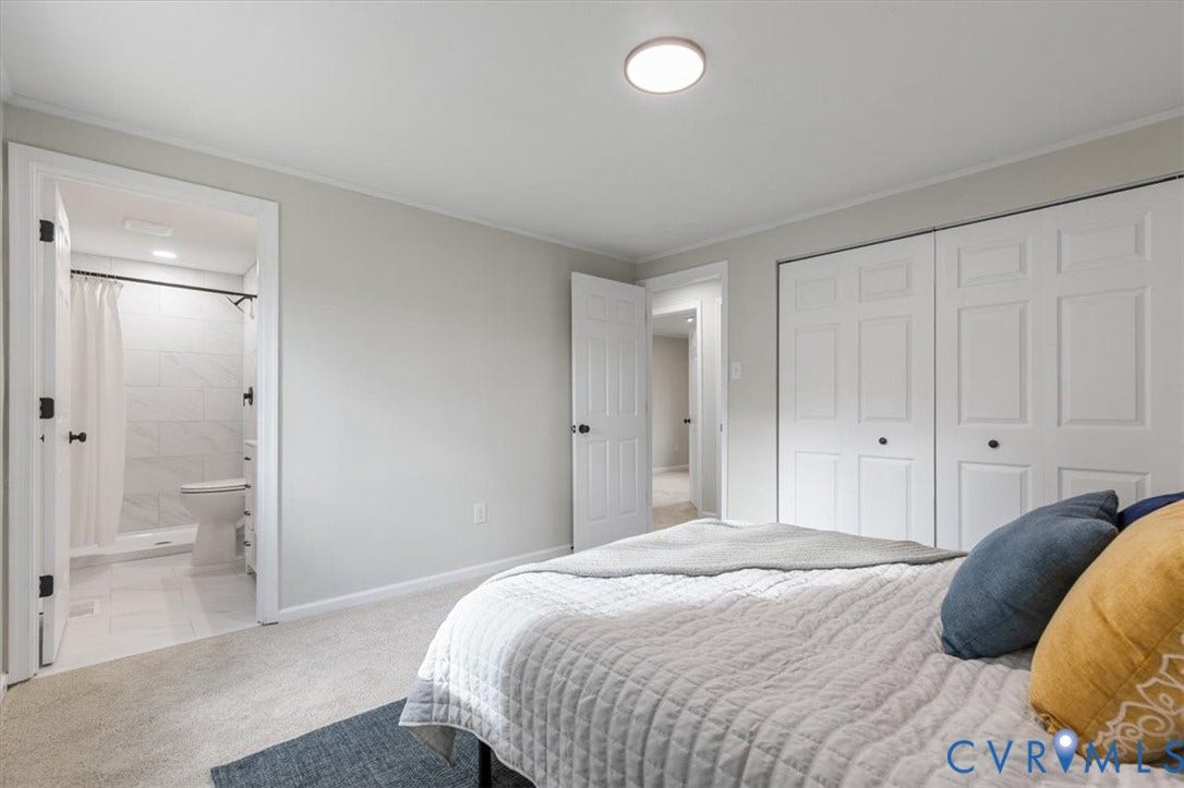 9201 Packard Court, Glen Allen, VA 23060 Neutral wall palette, carpeting, dual-panel closet doors, flush-mount lighting, and an entryway to a tiled bathroom with a shower enclosure
