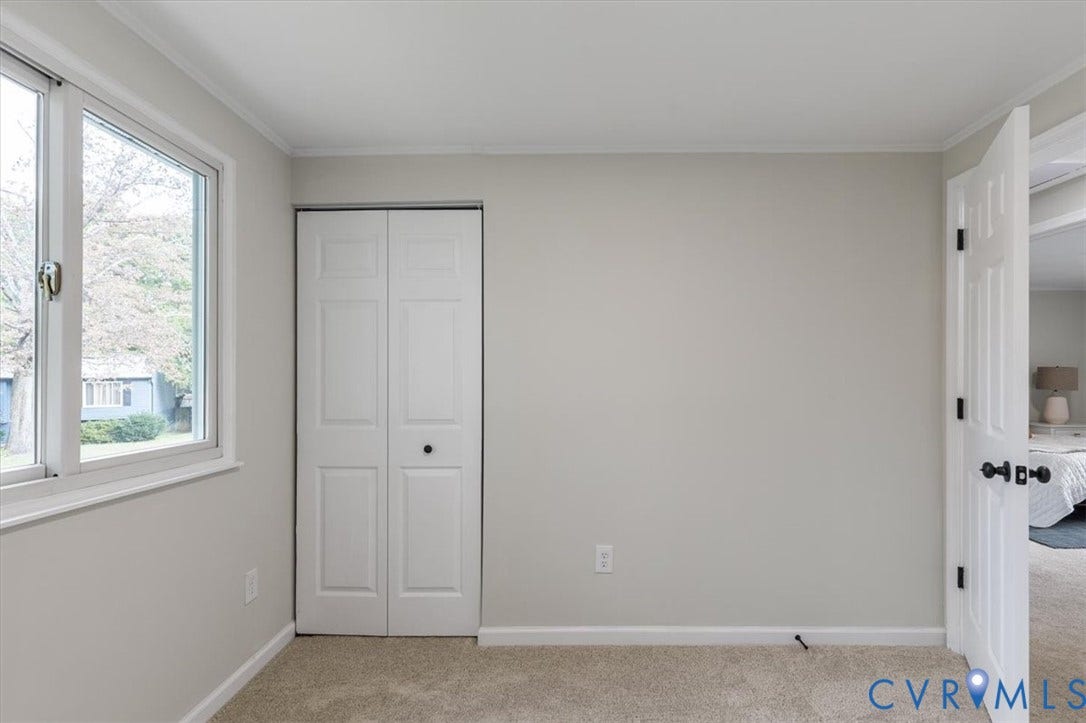 9201 Packard Court, Glen Allen, VA 23060 Neutral-toned walls, double-hung window, bi-fold closet doors, and carpeted flooring