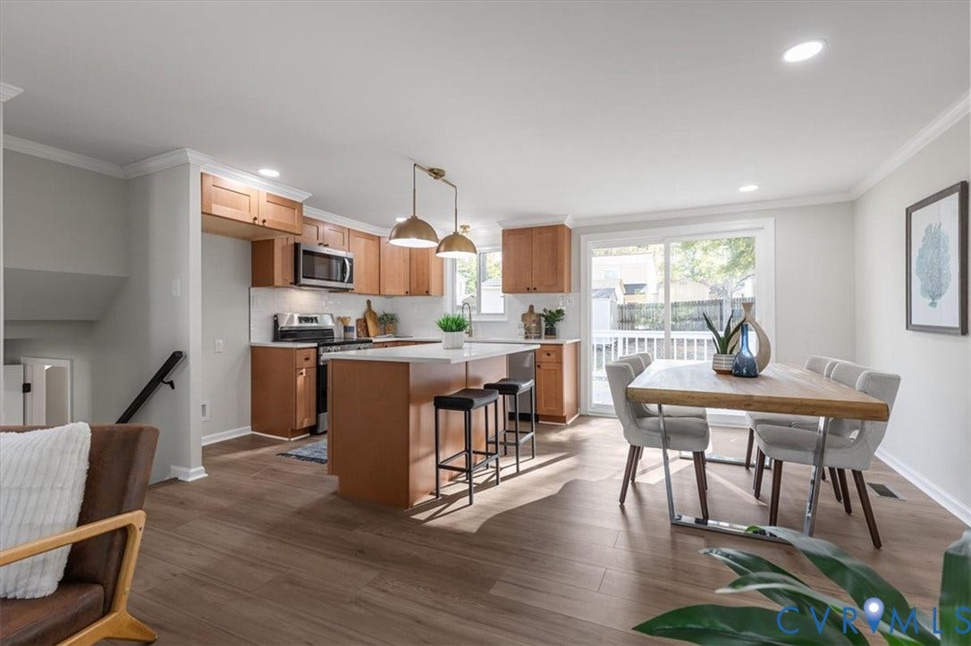 9201 Packard Court, Glen Allen, VA 23060 Kitchen featuring light wood-finish cabinetry, a central island with a solid-surface countertop, recessed lighting, and sliding glass doors