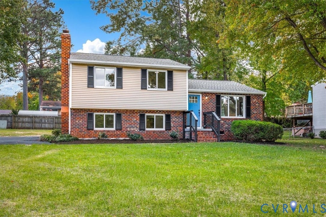 9201 Packard Court, Glen Allen, VA 23060 Split-level exterior featuring a brick and vinyl facade, exterior brick chimney, dual-tone siding, and an asphalt driveway