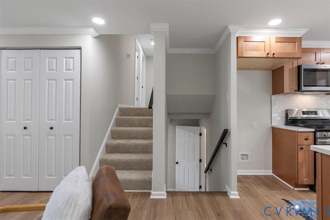 9201 Packard Court, Glen Allen, VA 23060 Kitchen featuring wood cabinetry, stainless steel appliances, and subway tile backsplash, complemented by wood-finish flooring, recessed lighting, and crown molding