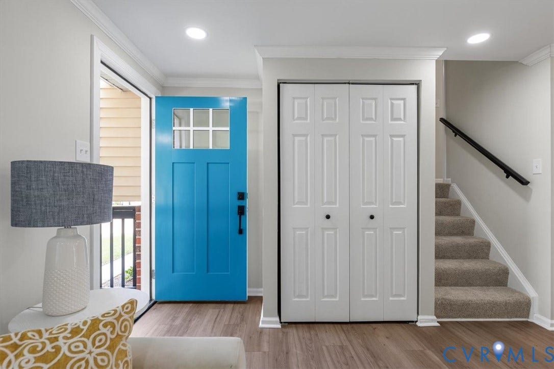 9201 Packard Court, Glen Allen, VA 23060 Entryway featuring a vibrant blue front door with a glass pane, wood-finish flooring, recessed lighting, double-door closet with six-panel doors, and staircase with a matte black wall-mounted handrail
