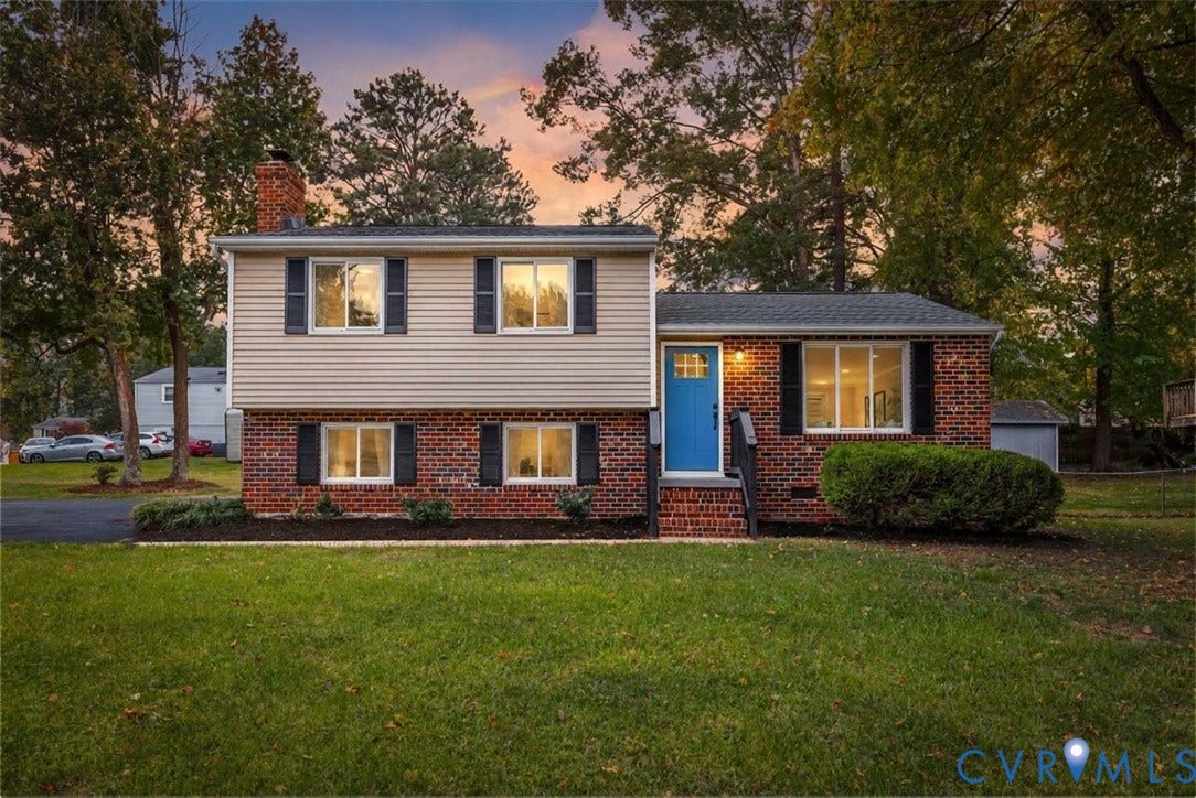 9201 Packard Court, Glen Allen, VA 23060 Split-level exterior featuring a brick and horizontal siding facade, multiple windows with dark shutters, a front entry door with a glass inlay, and a covered brick stoop