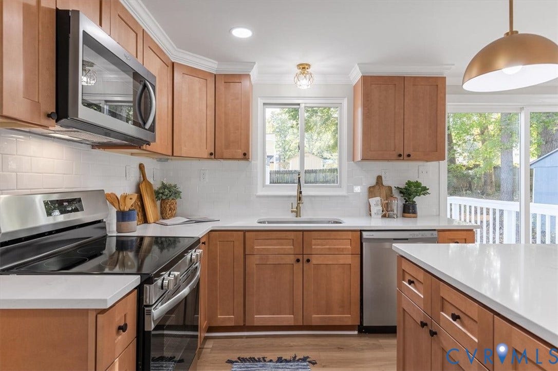 9201 Packard Court, Glen Allen, VA 23060 Kitchen featuring warm-tone wood cabinetry, white stone countertops, a white subway tile backsplash, stainless steel appliances, and a polished metal pendant light