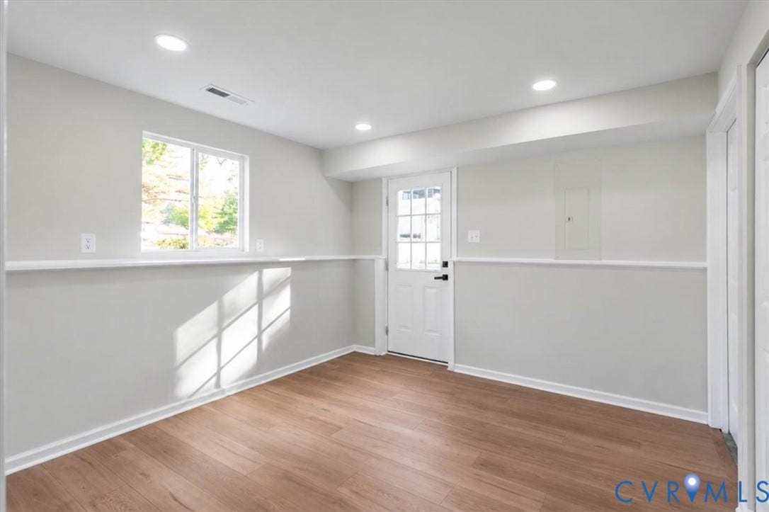 9201 Packard Court, Glen Allen, VA 23060 Interior space featuring wood-finish flooring, recessed lighting, neutral wall paint, a single-hung window with a chair rail, and an exterior door with a multi-pane glass insert