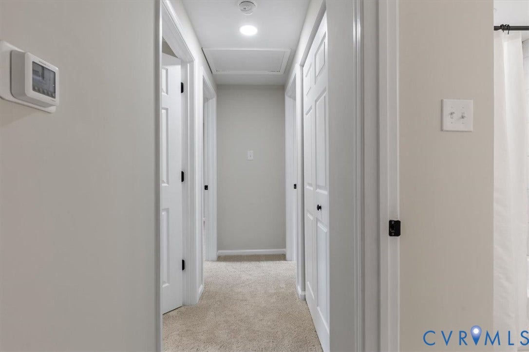9201 Packard Court, Glen Allen, VA 23060 Hallway featuring neutral wall paint, carpeted flooring, multi-panel interior doors, and a ceiling-mounted attic access panel