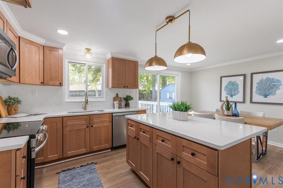 9201 Packard Court, Glen Allen, VA 23060 Kitchen featuring wood cabinetry, a central island with a solid-surface countertop, wood-finish flooring, and dual pendant lighting
