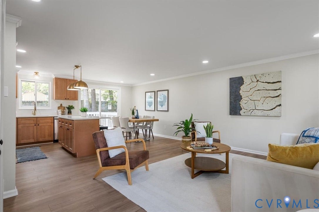 9201 Packard Court, Glen Allen, VA 23060 Open-concept living space featuring wood-finish flooring, recessed lighting, kitchen island with stone-finish countertop, and sliding glass doors