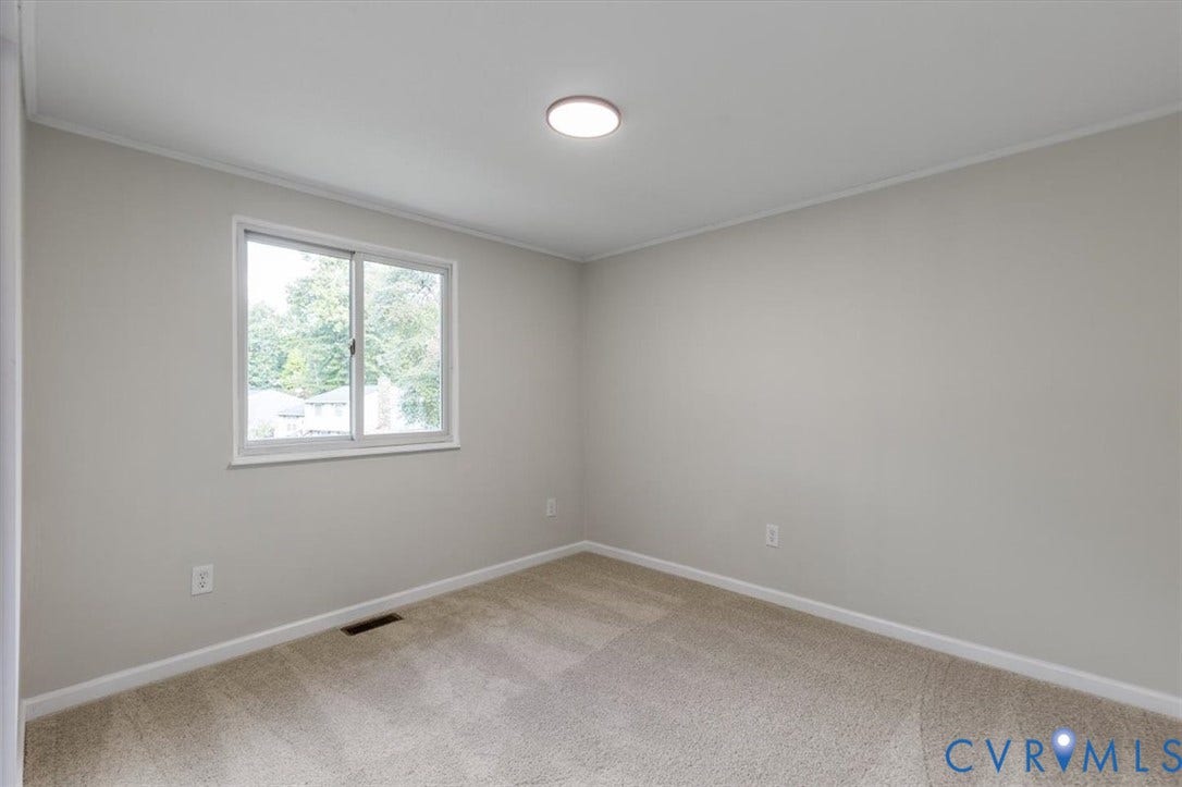 9201 Packard Court, Glen Allen, VA 23060 Neutral wall palette featuring wall-to-wall carpeting and a sliding window with clean white trim, accented by a flush-mount circular ceiling light