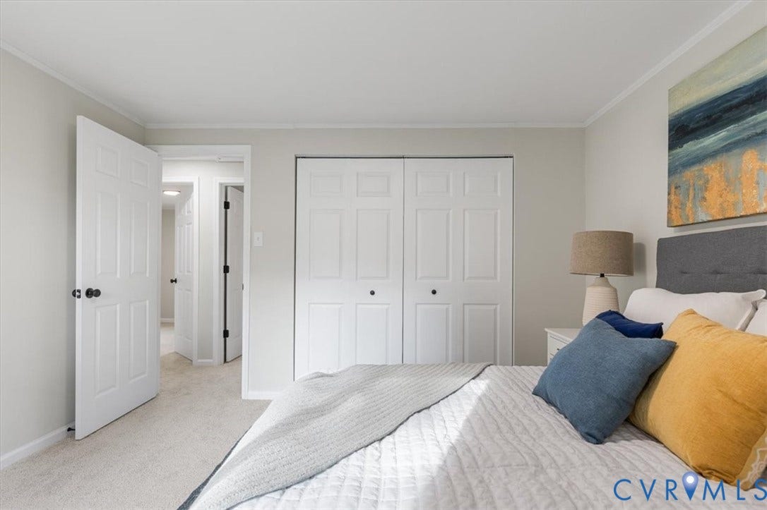 9201 Packard Court, Glen Allen, VA 23060 Room interior with neutral wall paint, carpeted flooring, and white interior doors featuring six-panel detailing and dark hardware
