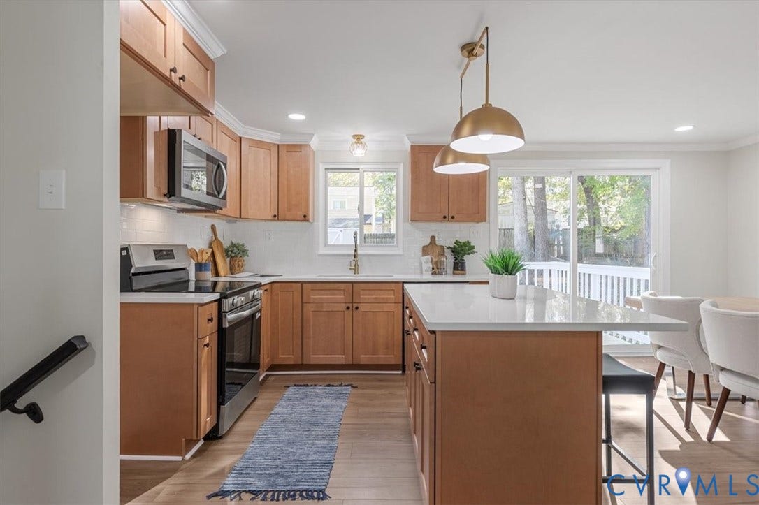 9201 Packard Court, Glen Allen, VA 23060 Kitchen featuring wood cabinetry, an island with a light-toned countertop, stainless steel appliances, recessed ceiling lighting, and pendant fixtures