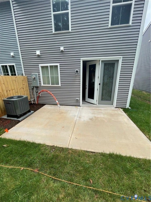 9212 St Charles Circle, Richmond, VA 23235 Exterior featuring horizontal gray siding, concrete patio, sliding glass door, and exterior HVAC unit