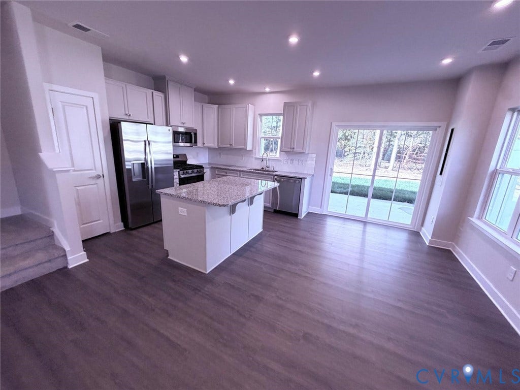10600 Pink lily Lane, Chesterfield, VA 23234 Kitchen featuring white cabinetry, stone-finish countertops, a central island, stainless steel appliances, and wood-finish flooring